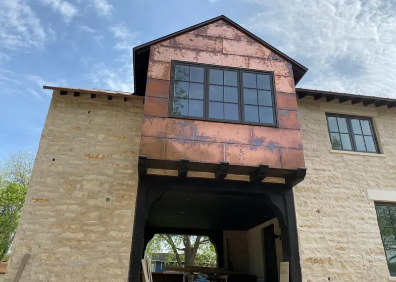 Copper metal panel facade on a stone building for Skylight Installation in Gridley