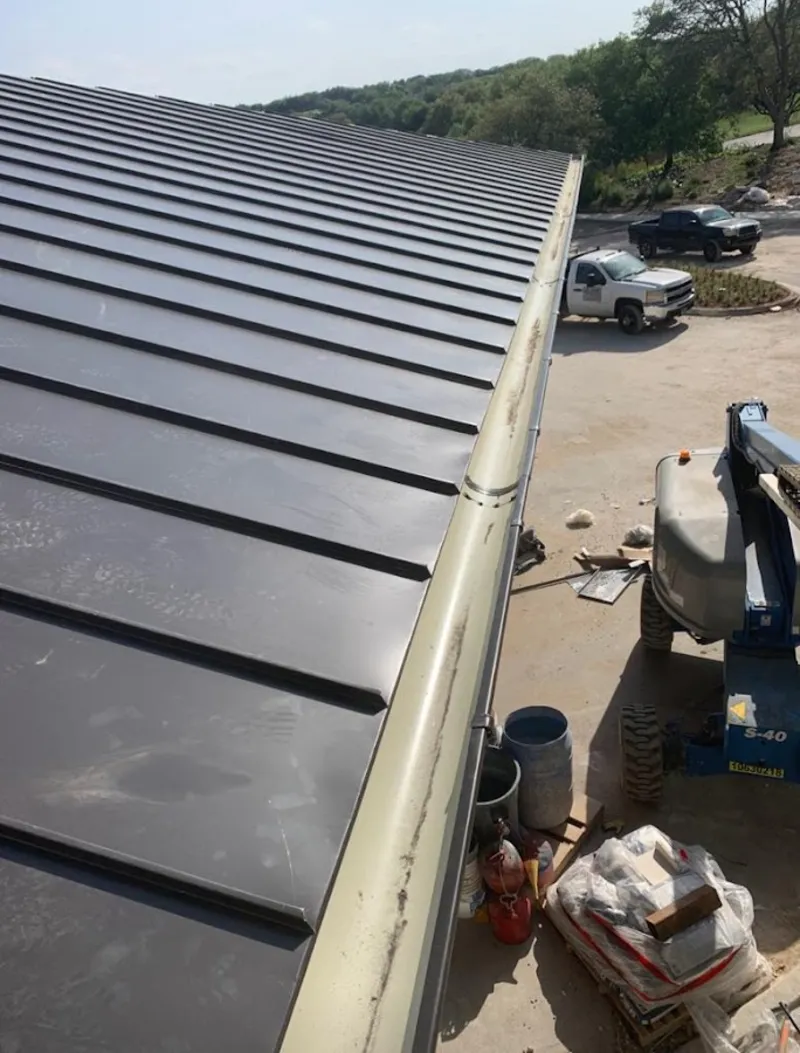 Standing seam panel and gutter detail on a metal roofing jobsite in Gridley